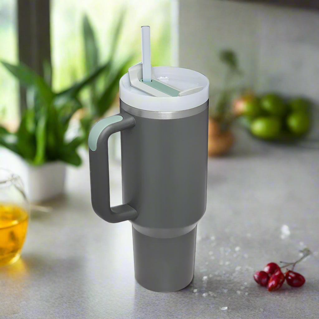 Gray travel mug with a handle and straw.
