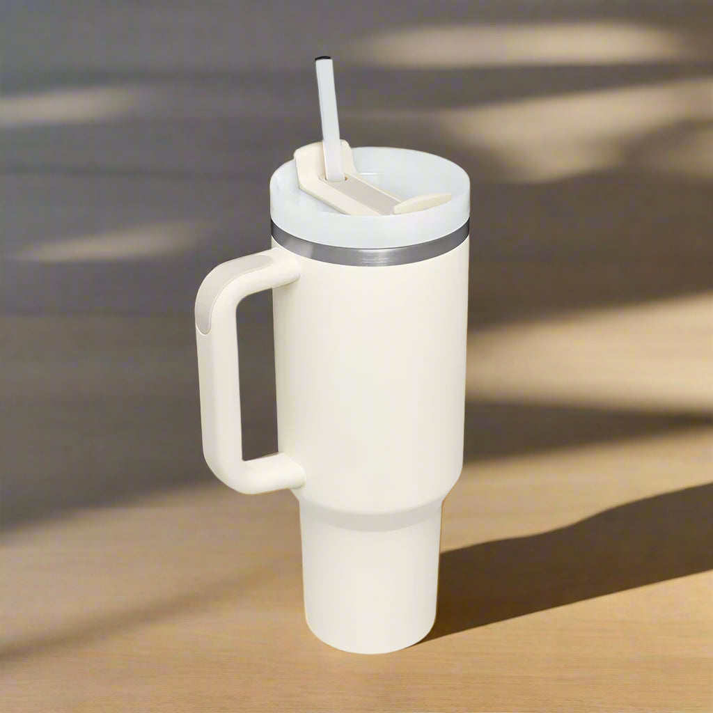 White tumbler with handle and straw.