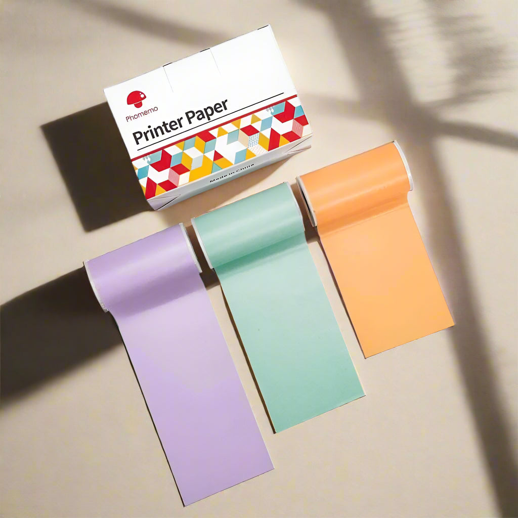 Three rolls of colorful printer paper with a box labeled 'Printer Paper' to use on mini printer