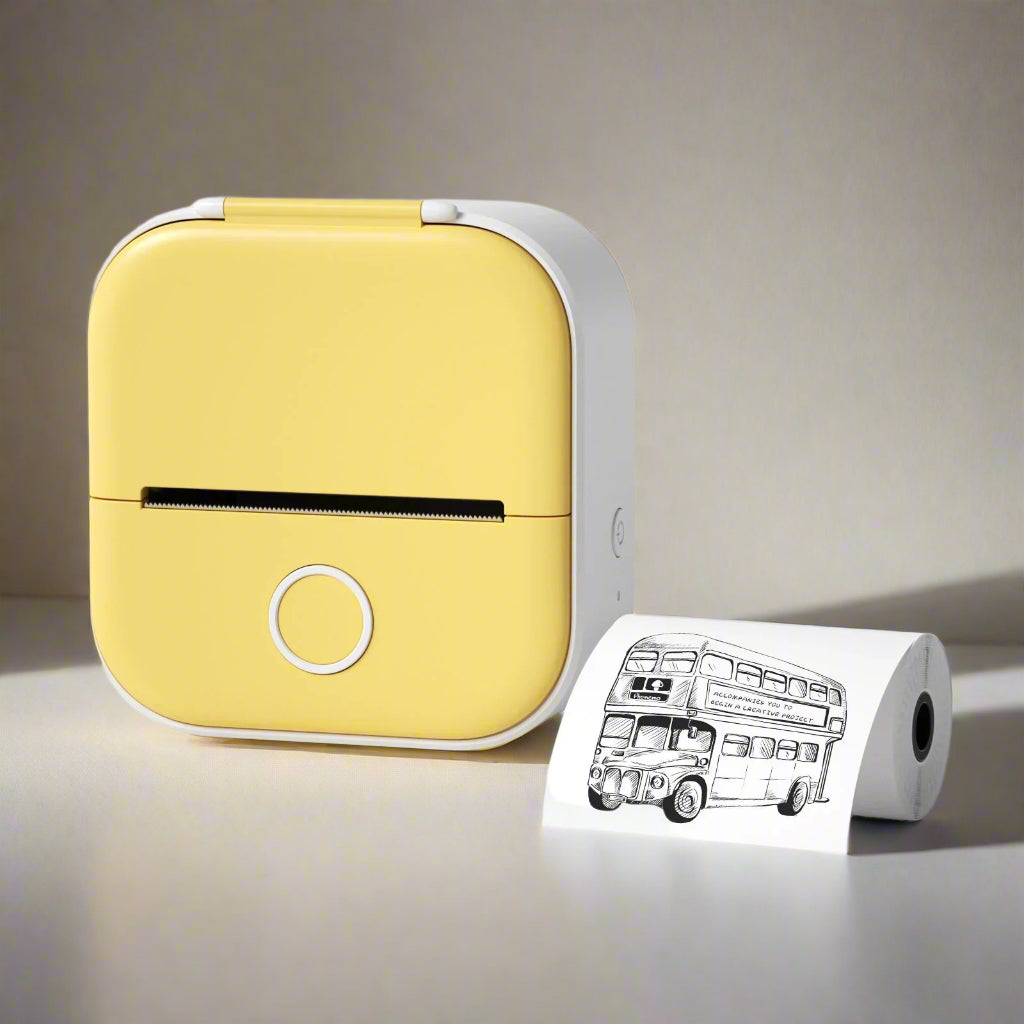 Yellow portable printer with a roll of paper featuring a black and white illustration of a London bus 